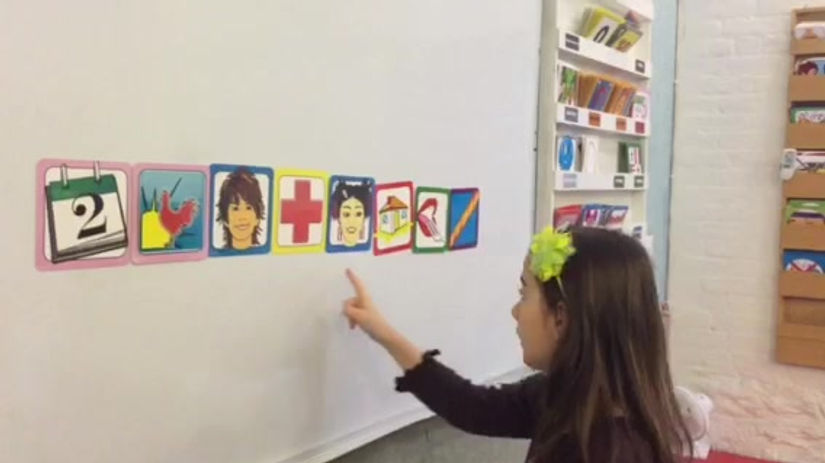 Student using flash cards to speak three languages